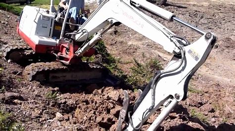 mini excavator digging side of hill|mini excavators working videos.